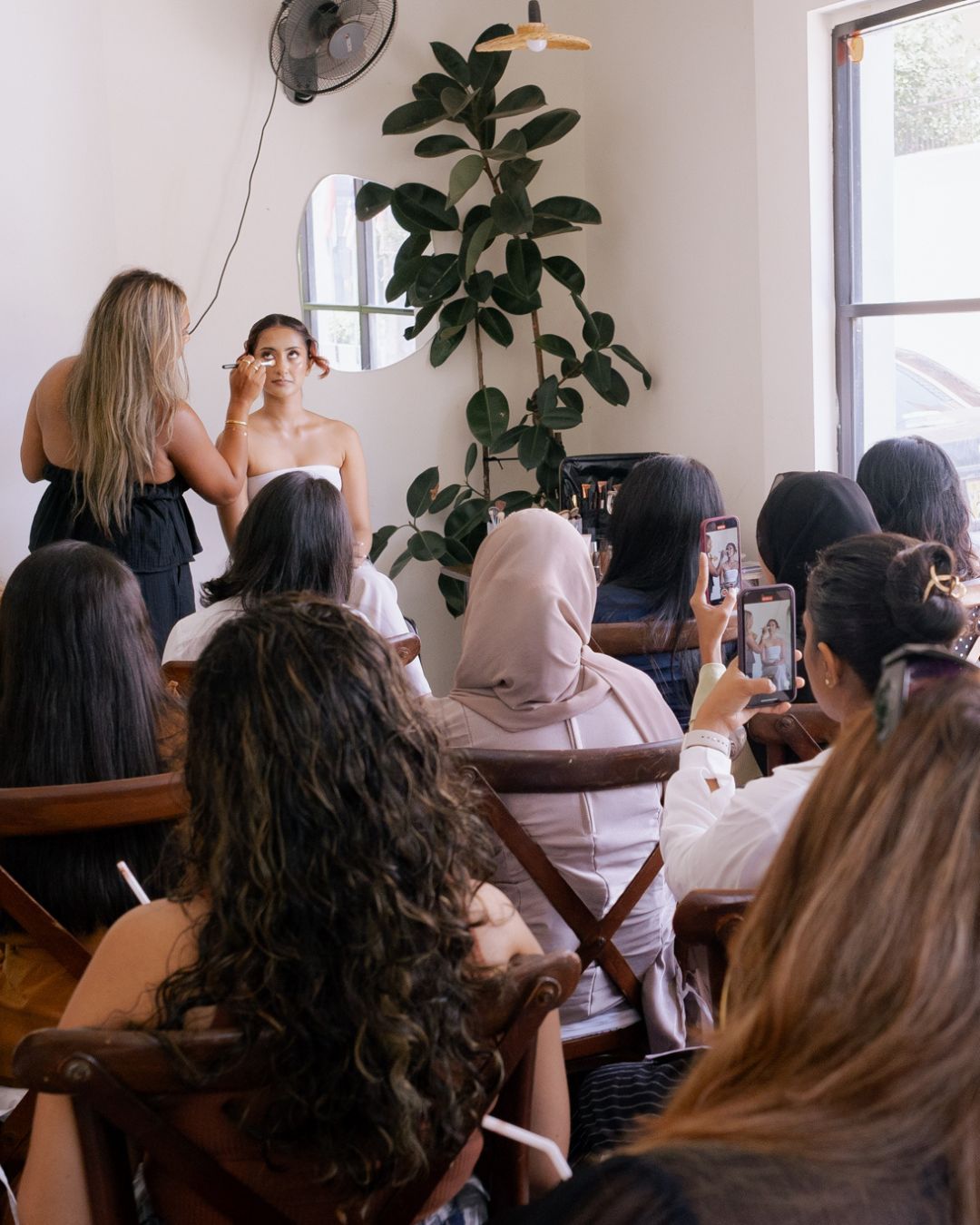 Attendees watching the live makeup demonstration